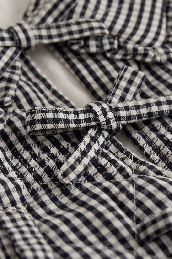 Close-up of a black and white checkered fabric with a bow