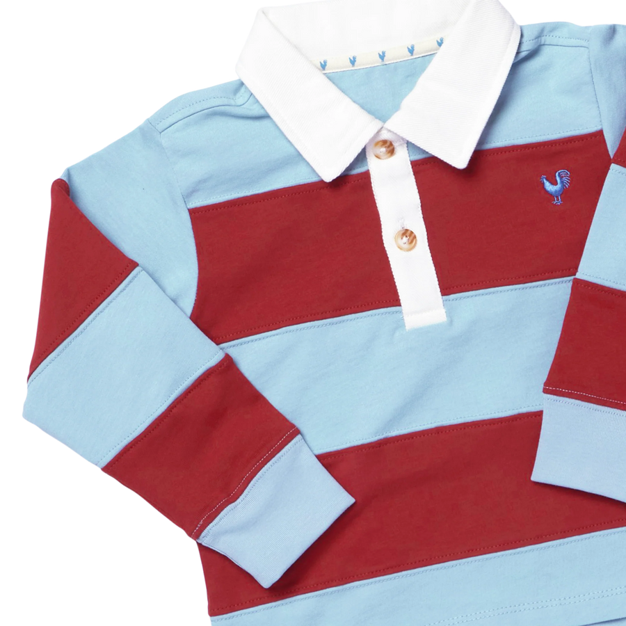 A long-sleeve baby rugby polo shirt with horizontal stripes in light blue and deep red, featuring a white collar, two gold buttons, and a small embroidered blue rooster logo on the chest.
