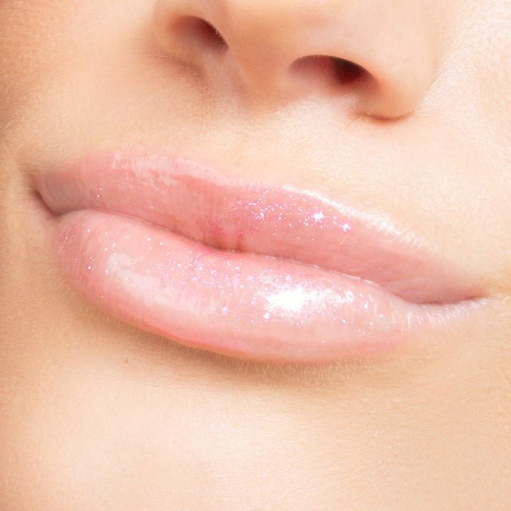 Close-up of glossy lips with a soft focus on skin texture