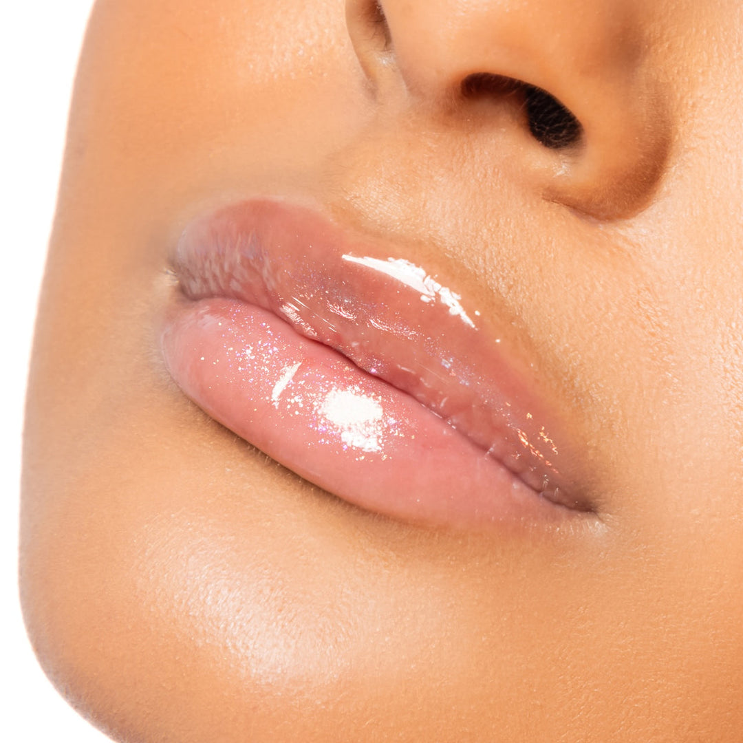 Close-up of a person's lips with a glossy lip product on a white background