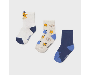Three pairs of socks with cartoon designs on a light gray background