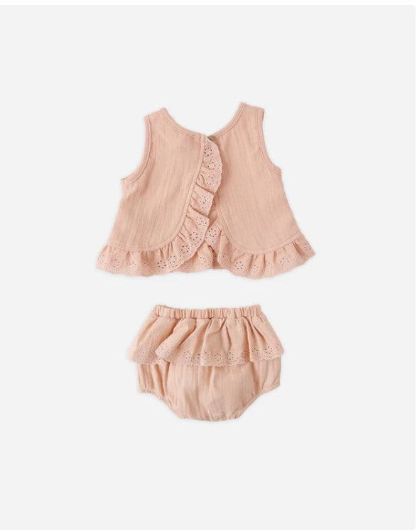 Pink baby outfit with top and bloomers on a white background