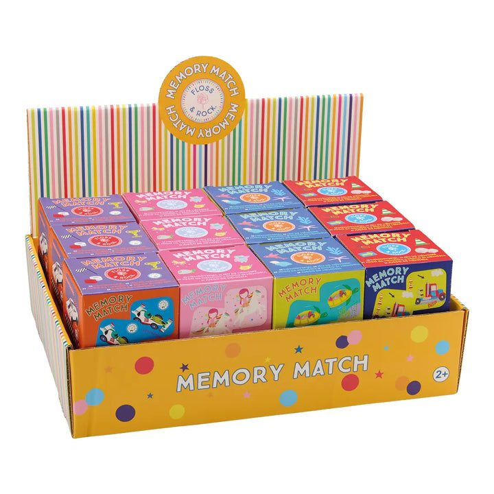 Display of colorful 'Memory Match' game boxes with a striped background