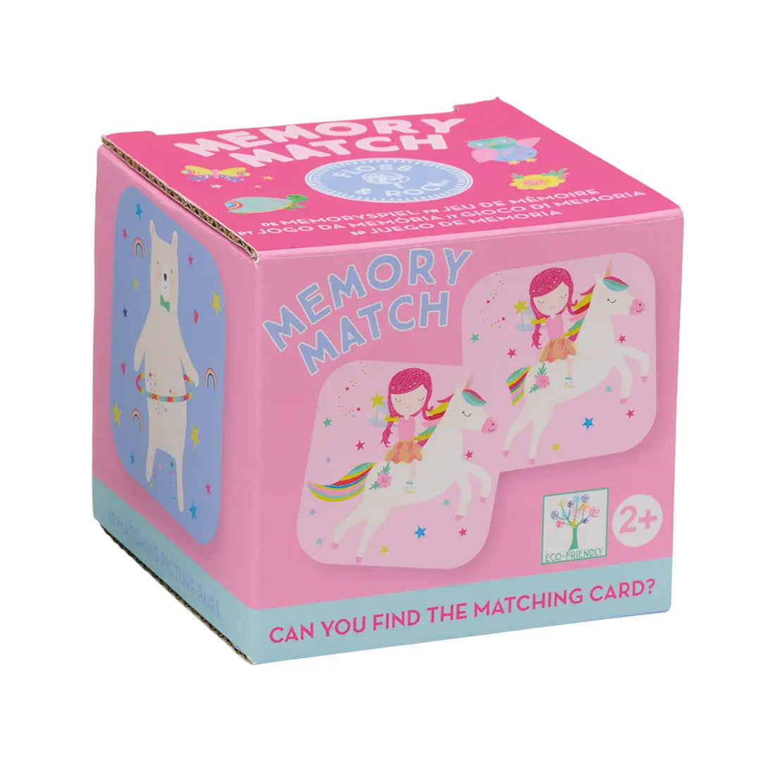 Pink packaging of a memory match game with illustrations of a girl and unicorn on a white background