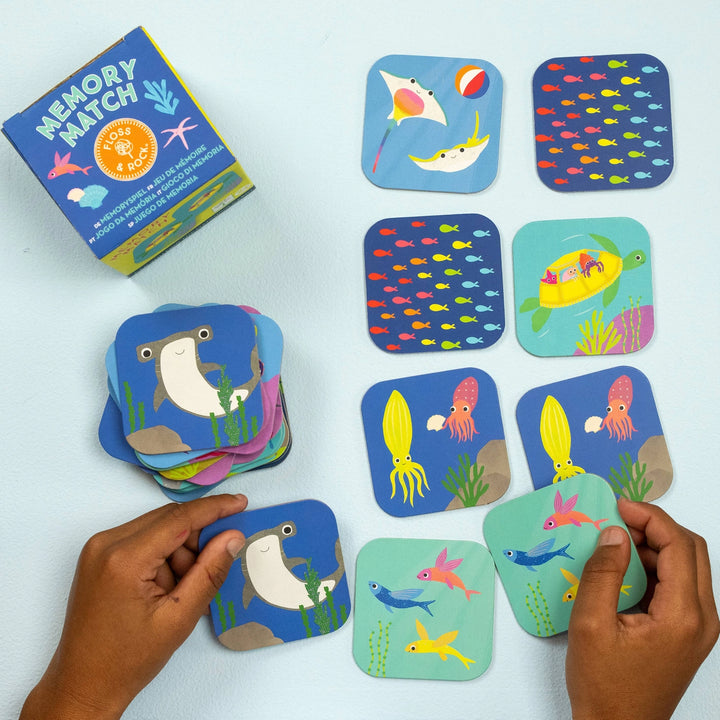 Children's memory match game with ocean-themed cards on a light blue background