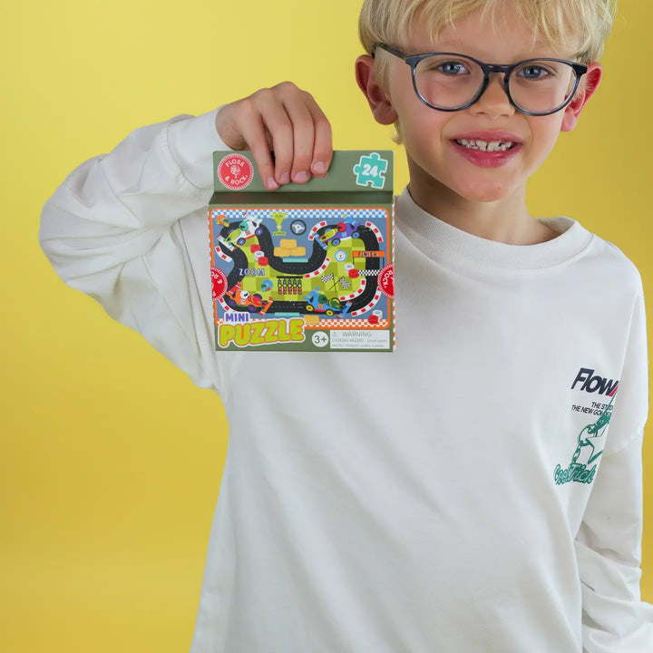 boy holding a mini jigsaw puzzle about cars 