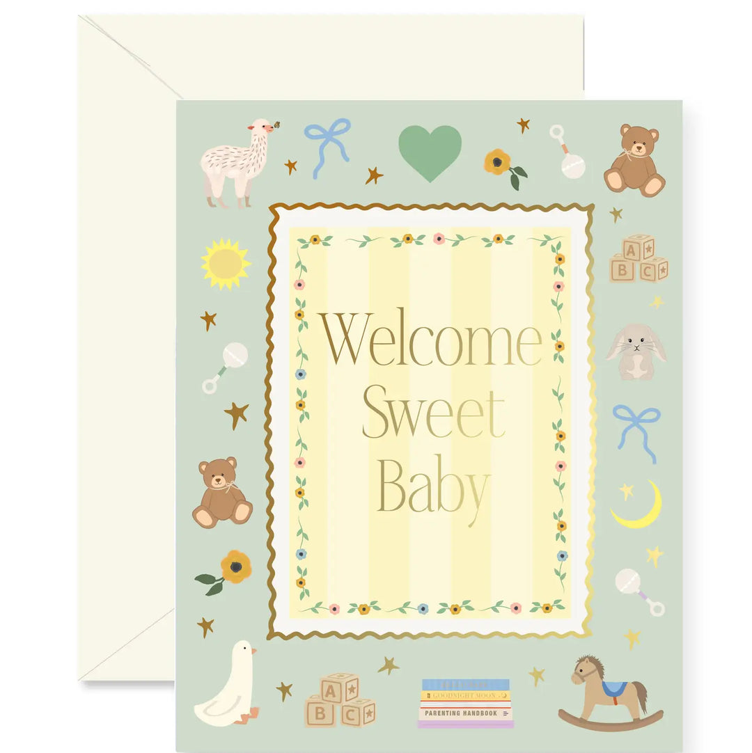 A baby shower greeting card with a pale green background and a cream envelope behind it. The card features the words 'Welcome Sweet Baby' in a decorative central panel surrounded by illustrations of baby-themed items including a lamb, teddy bear, bunny, rocking horse, stars, and blocks.