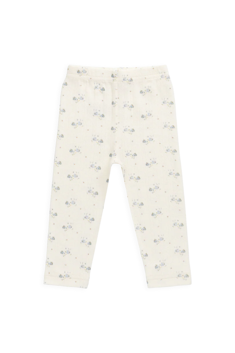 White pants with small blue floral pattern on a white background