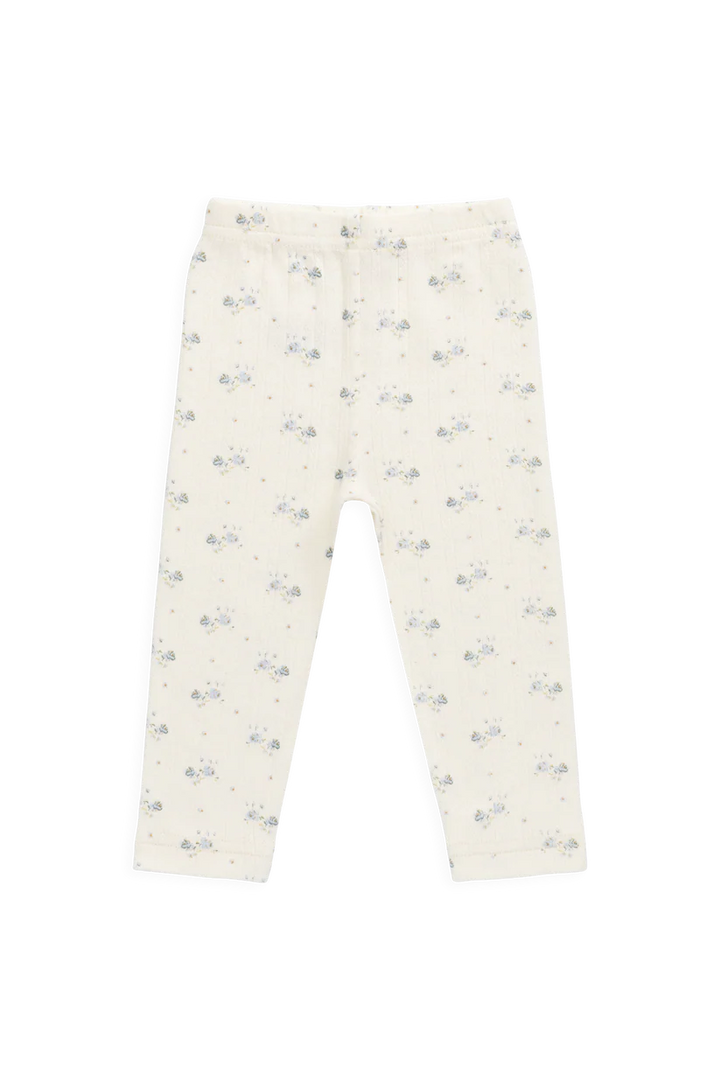 White pants with small blue floral pattern on a white background
