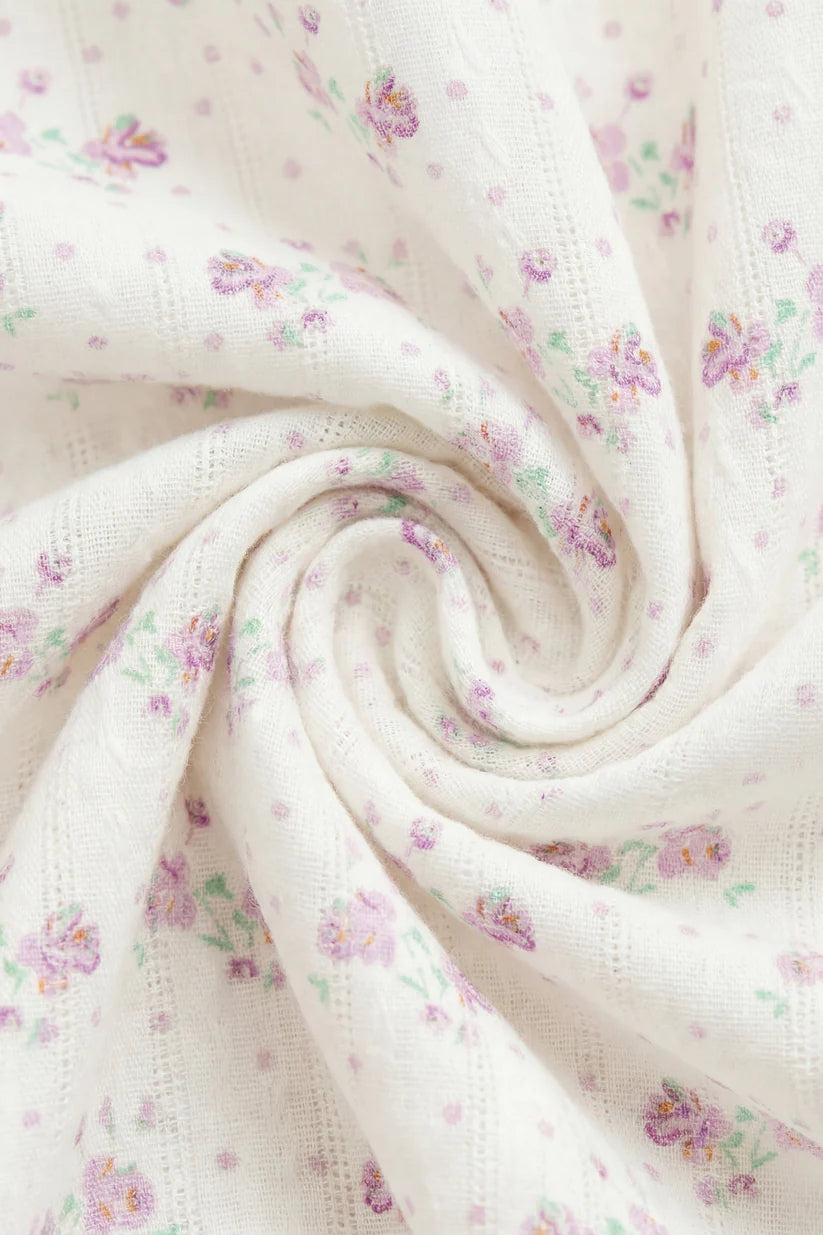 Floral patterned fabric with small flowers on a white background
