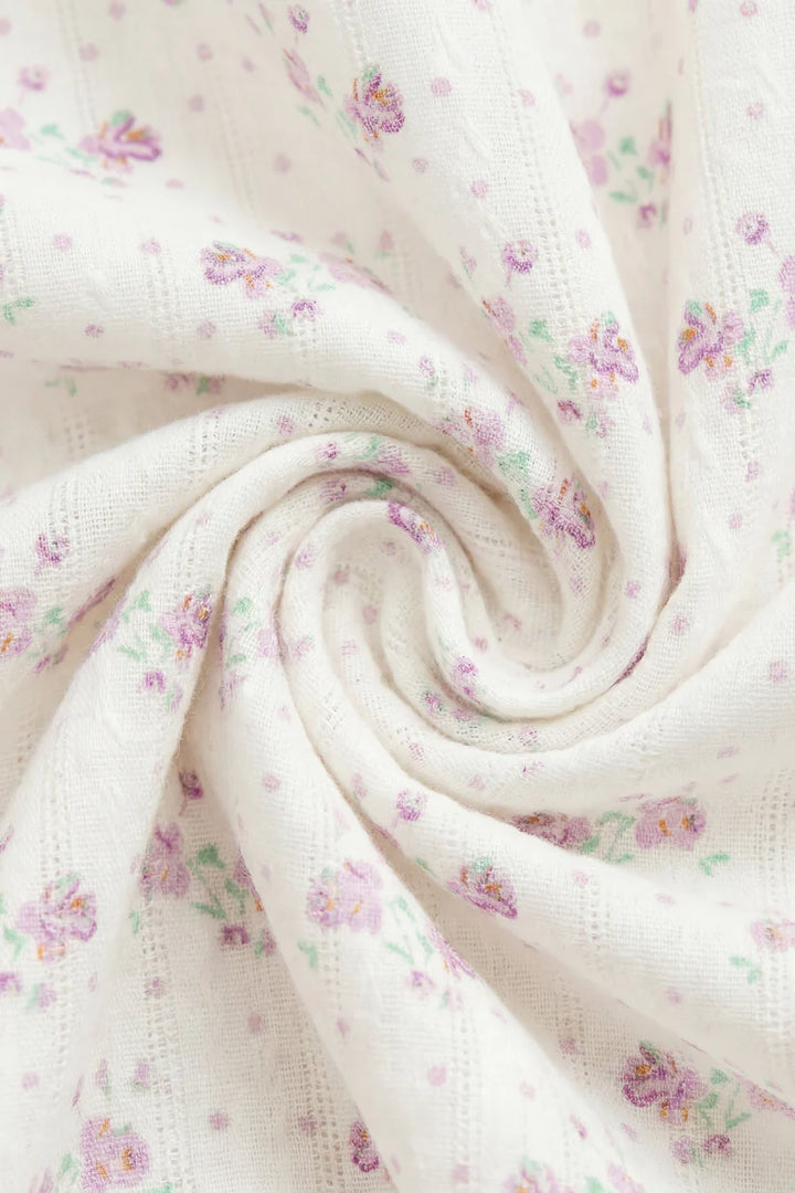 Floral patterned fabric with small flowers on a white background