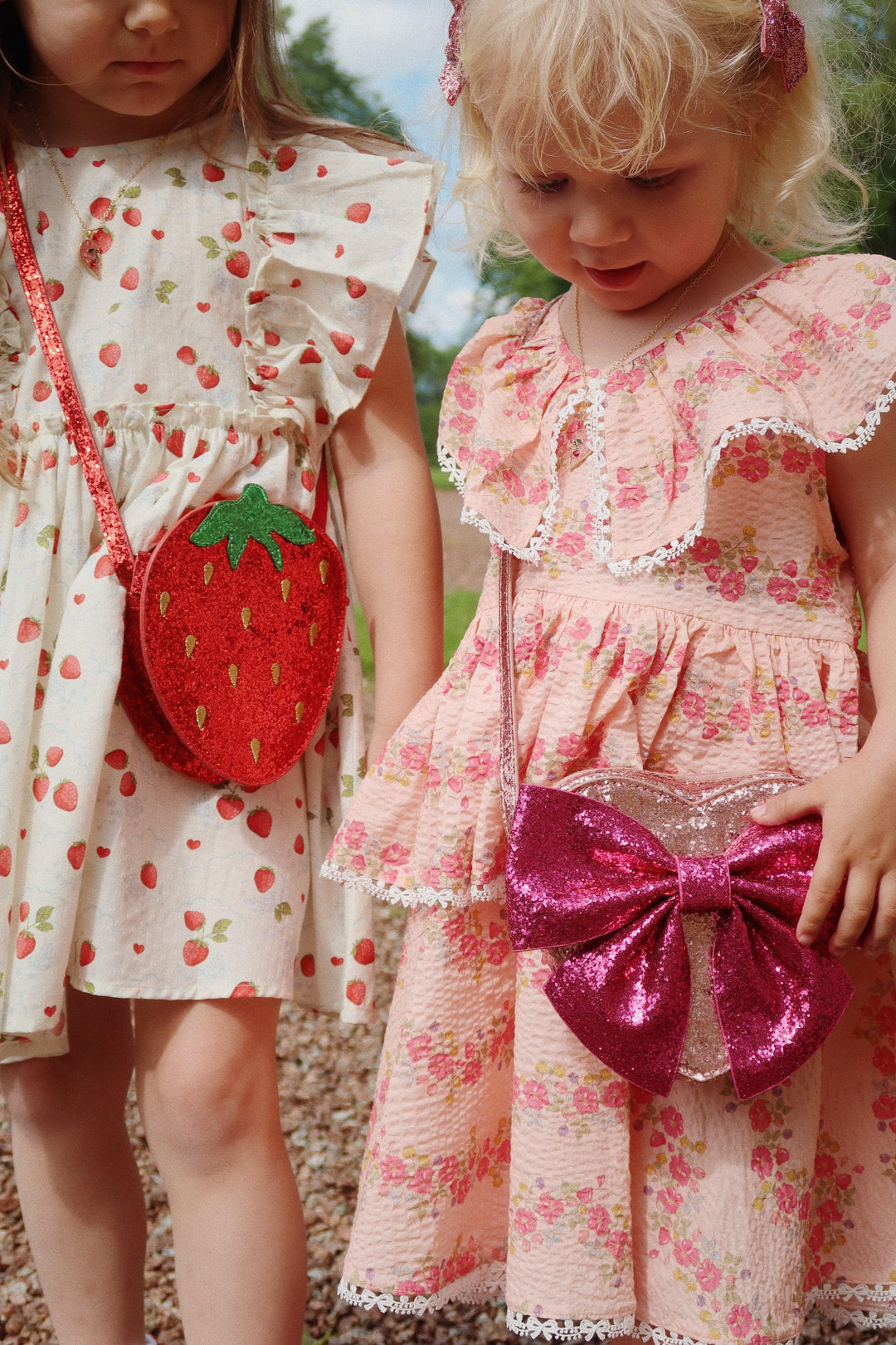 little girl modeling the pink dress with and the pink bow bag. 