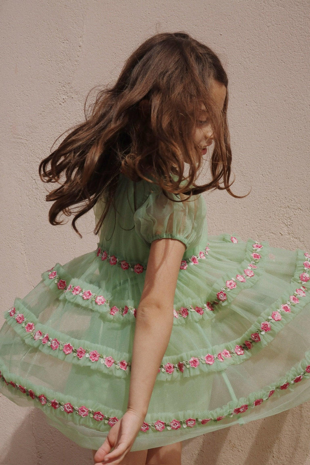 little girl twirling from another angle and you are able to see the dress and the skirt from another angle. lots of movement in the dress. 