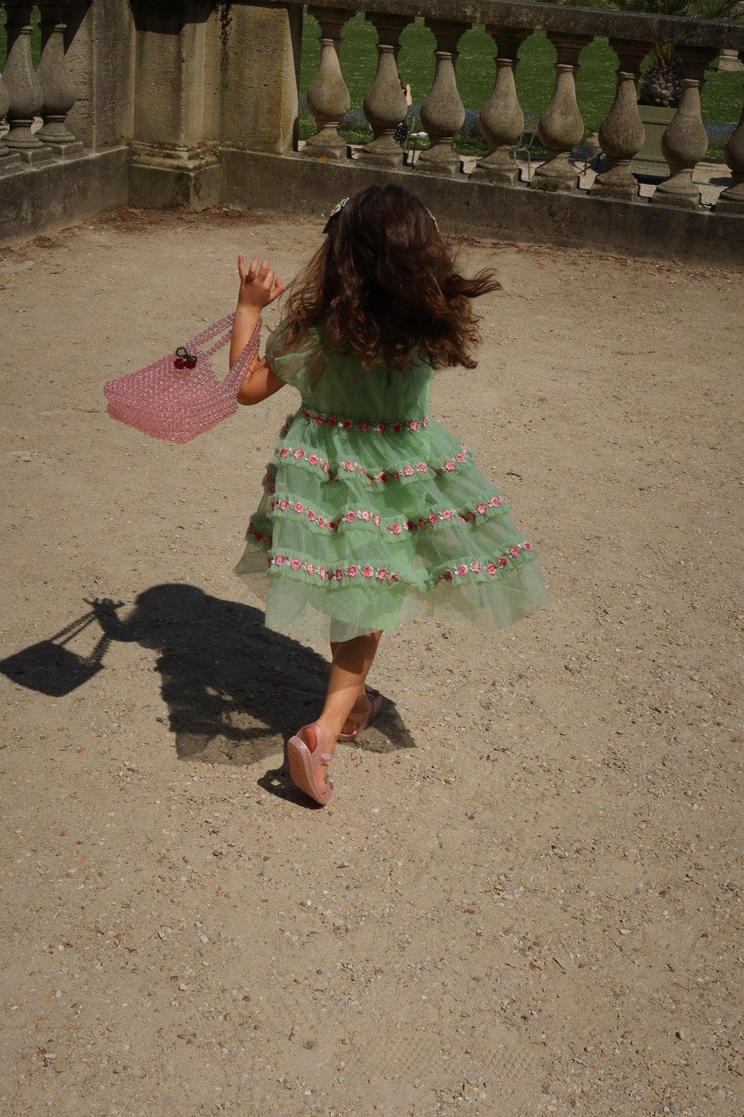 little girl wearing the green tulle dress and running so you can see the movement in the dress and how the skirt moves about. 