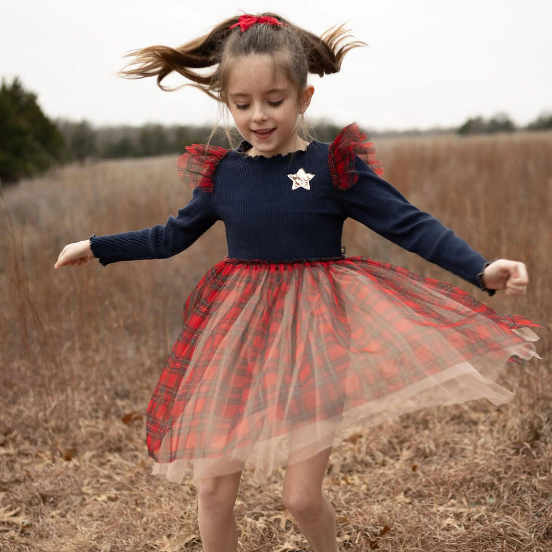 little girl spinning around in the tutu dress showing off the plaid tulle 