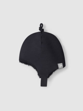 navy baby hat with fur lining that is made of organic cotton