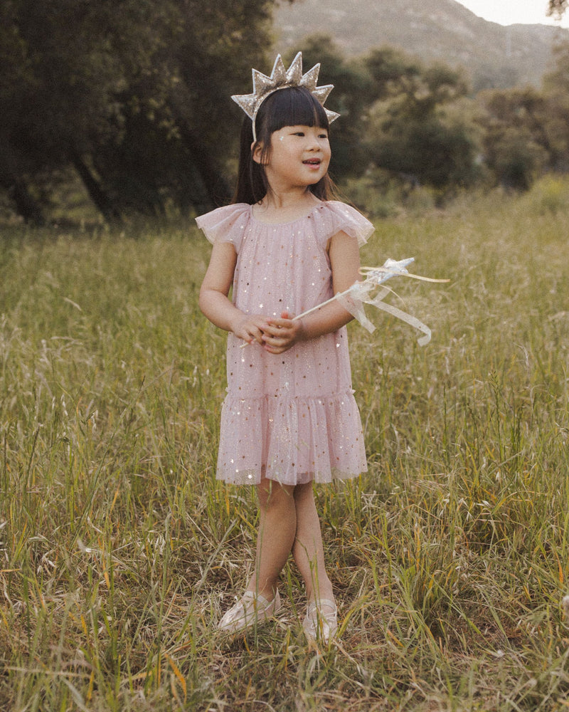 This is another picture of the model in the dusty rose dress. the dress shows where it will hit the child: at the knee. 