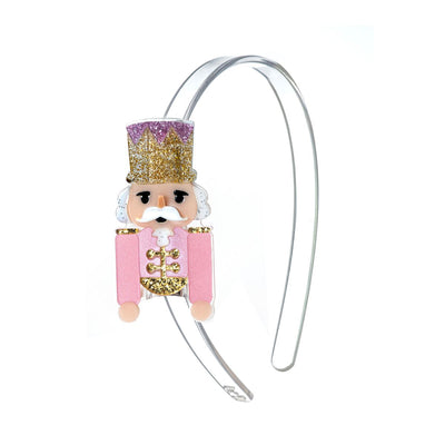 acrylic girls headband with pink nutcracker wearing a gold and purple hat