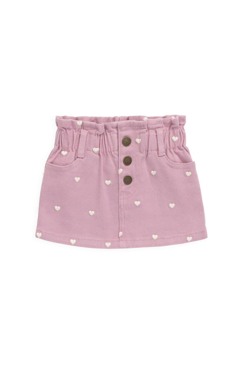 Pink denim skirt with heart patterns and button details on a white background