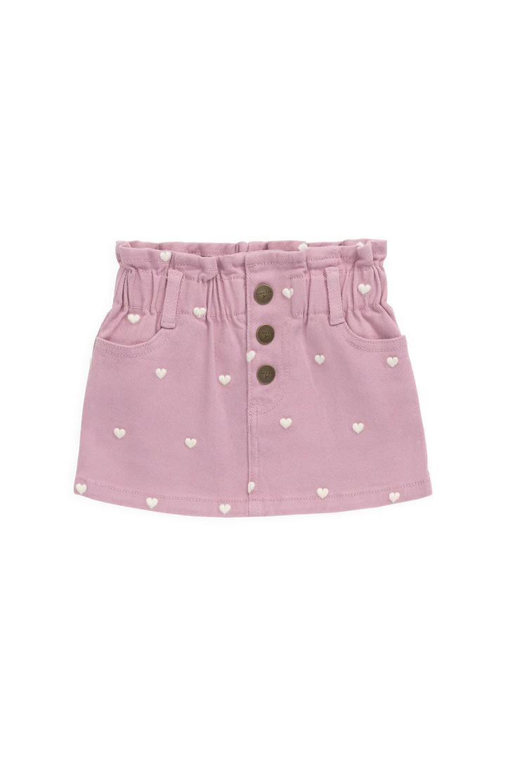 Pink denim skirt with heart patterns and button details on a white background