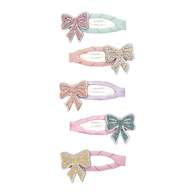 Set of six colorful hair clips with bow designs on a white background