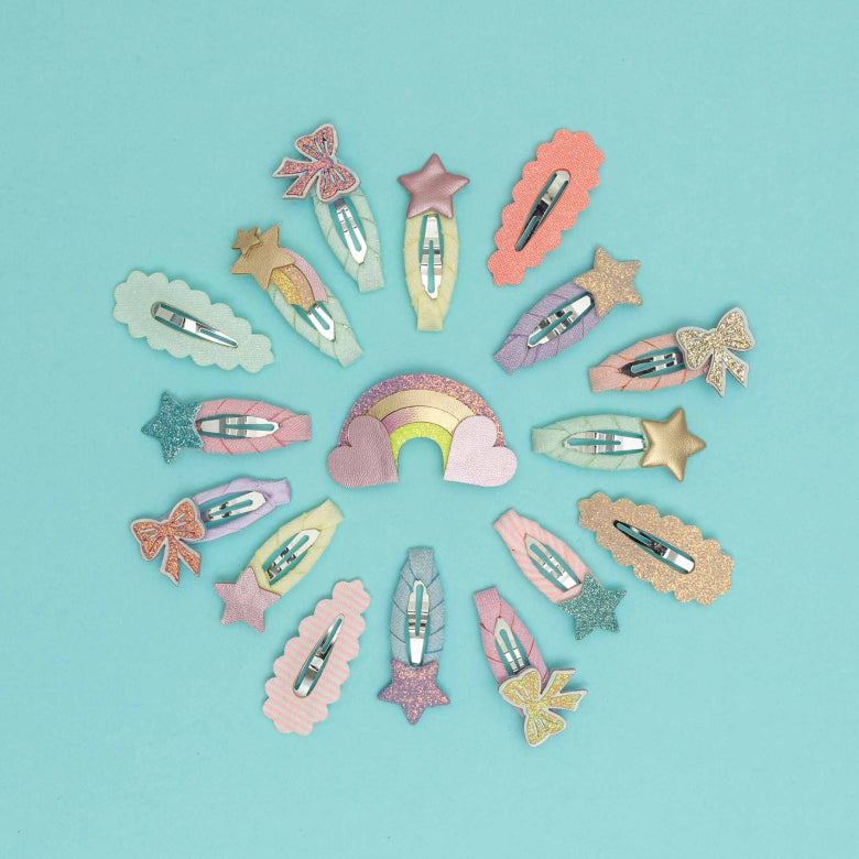 Colorful hair clips arranged in a circular pattern on a light blue background