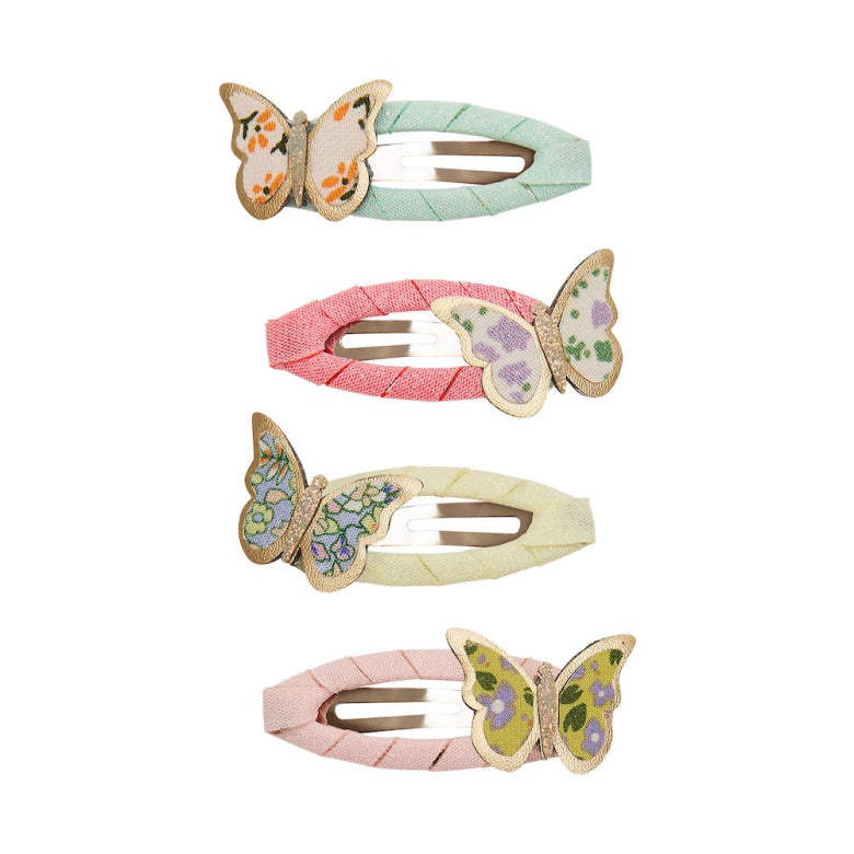 Set of four butterfly-themed hair clips on a white background