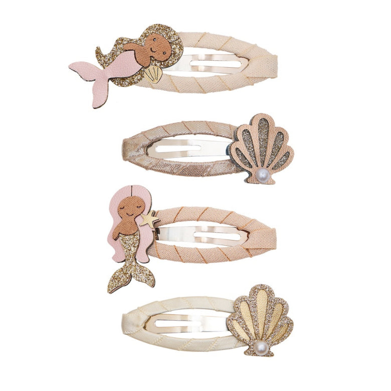 Set of four hair clips with mermaid and shell designs on a white background
