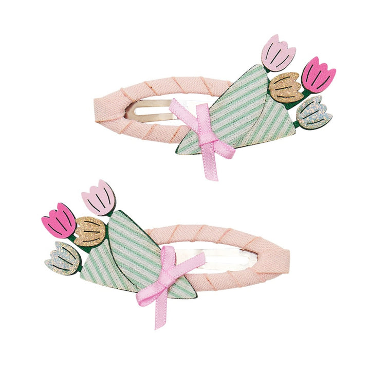 Two floral-themed hair clips with pink ribbons on a white background