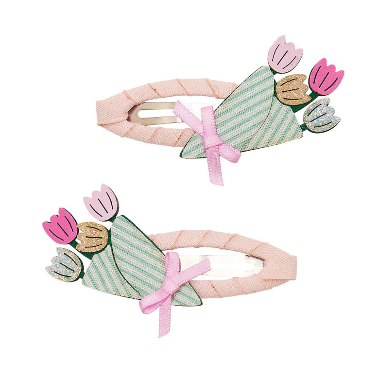 Two floral-themed hair clips with pink ribbons on a white background