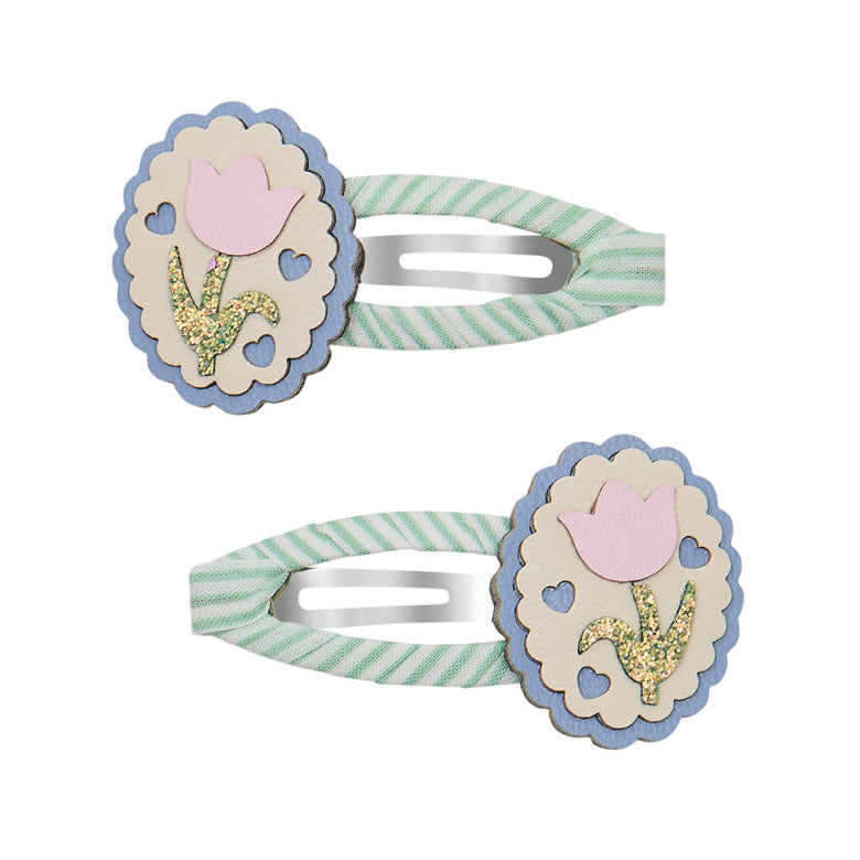 Two decorative hair clips with floral designs on a white background