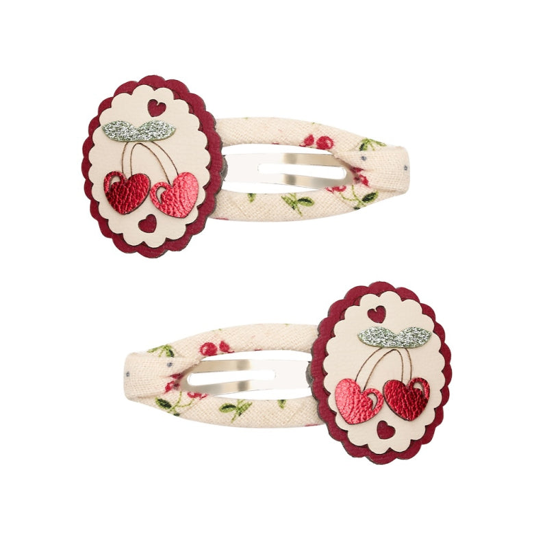 Pair of hair clips with cherry design on a white background