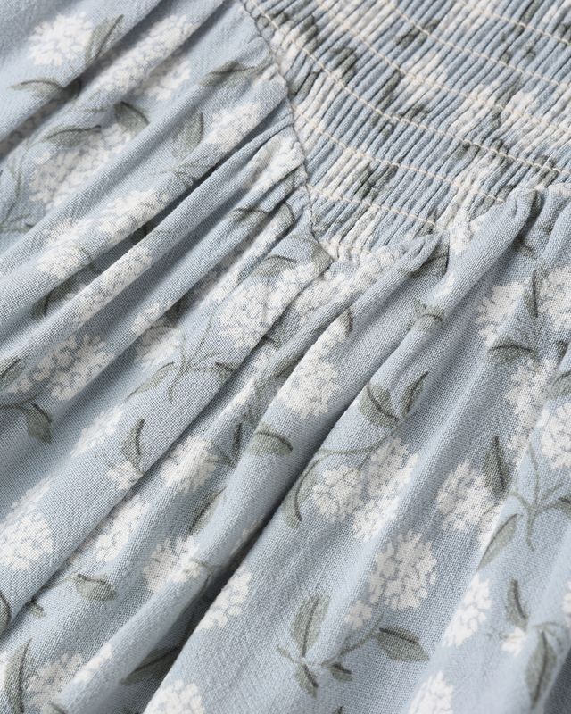 Close-up of textured fabric with floral pattern on a light blue background