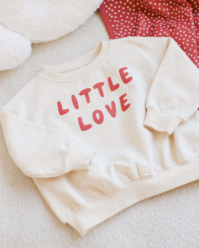 another picture with the close up of the sweatshirt that says "Little Love" written in burgundy/red across the center