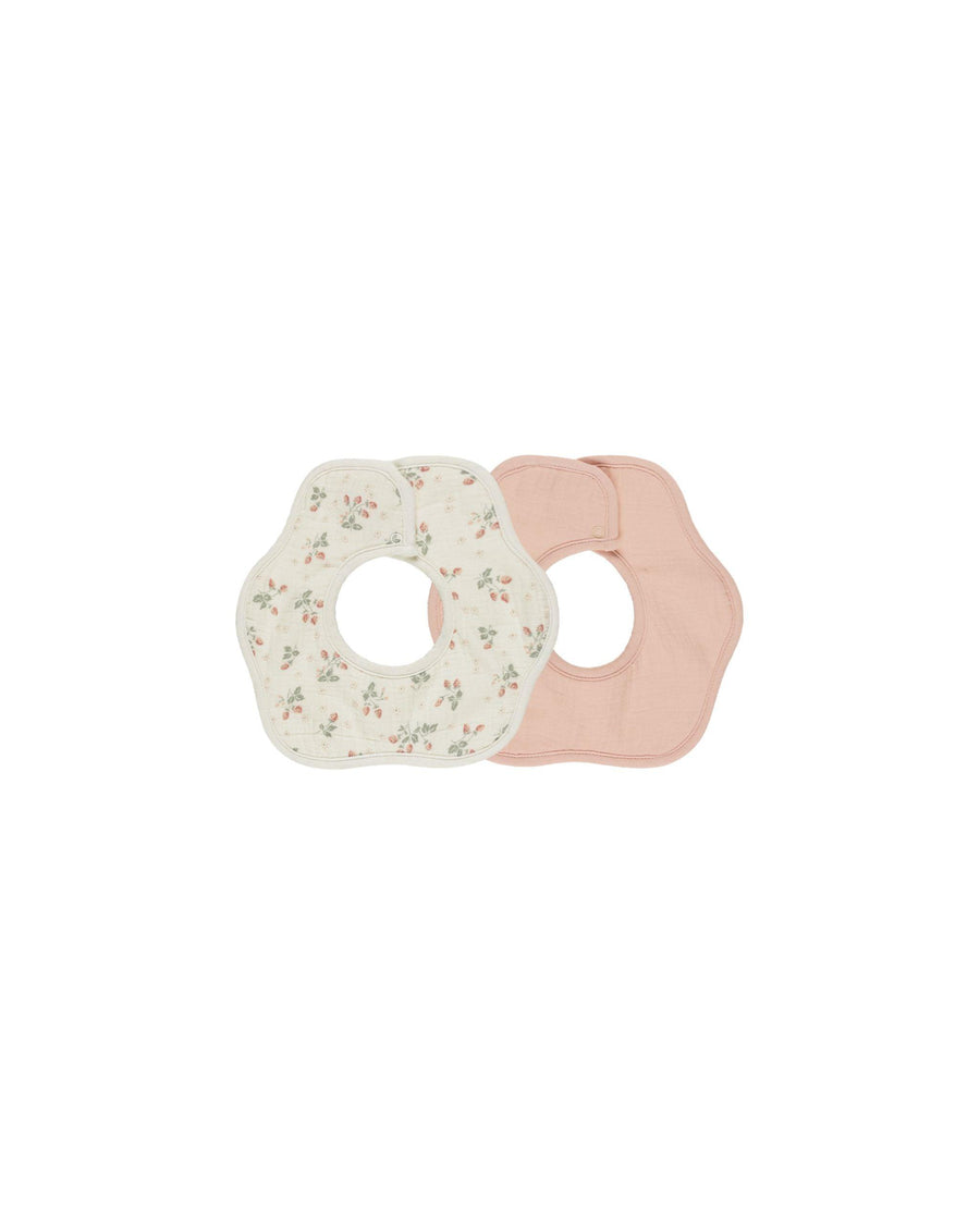 set of 2 bibs in the shape of a flower- one beige with tiny strawberries and one in a peachy/pink color