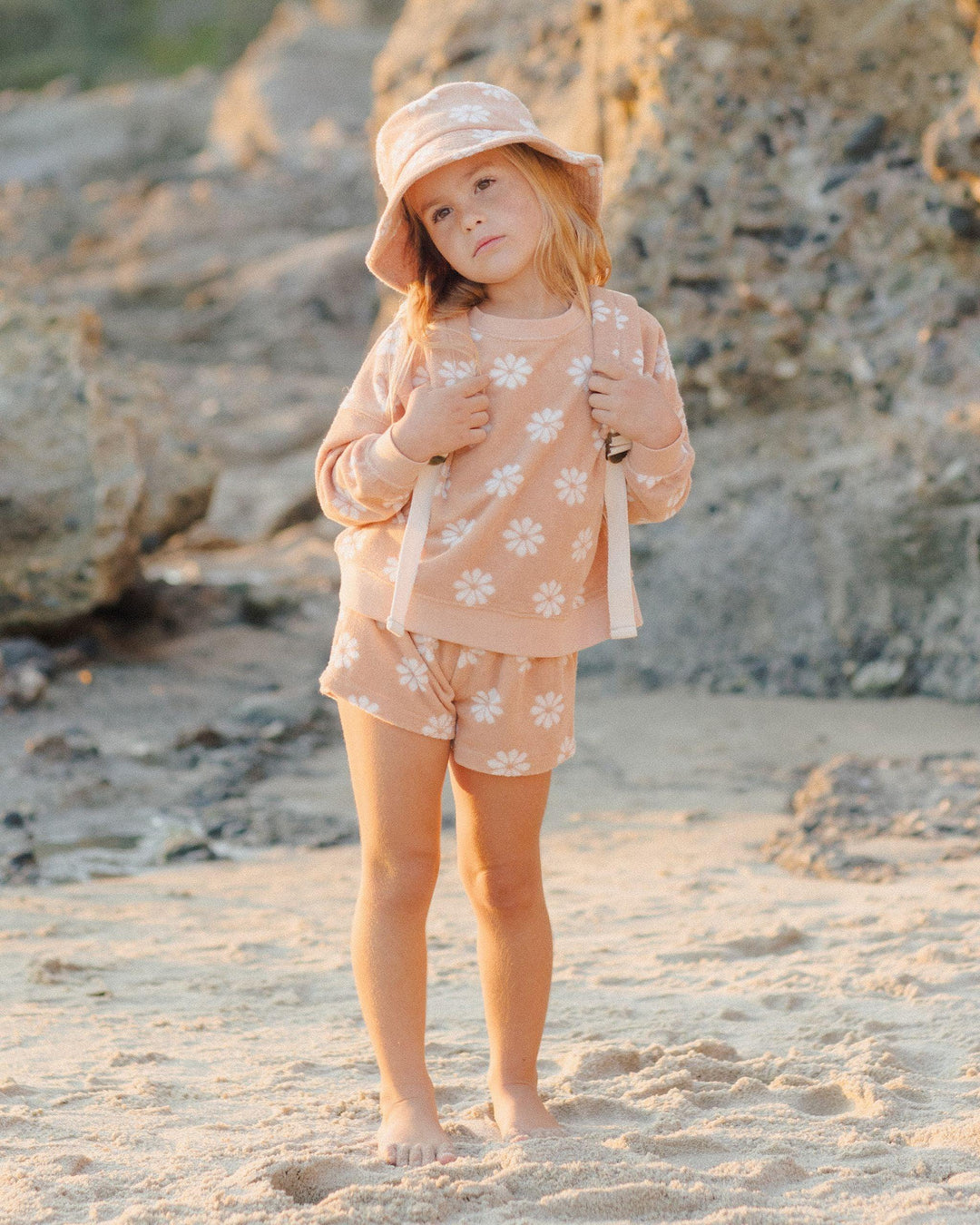 little girl modeling the terry cloth set,top hits below the waist and shorts hit mid thigh. 