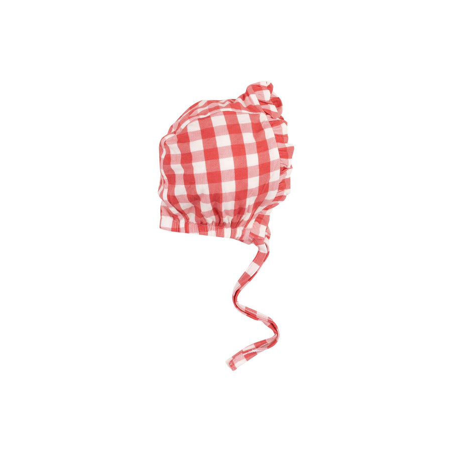 red and white gingham check baby bonnet with ruffles at the edge. ties under the chin