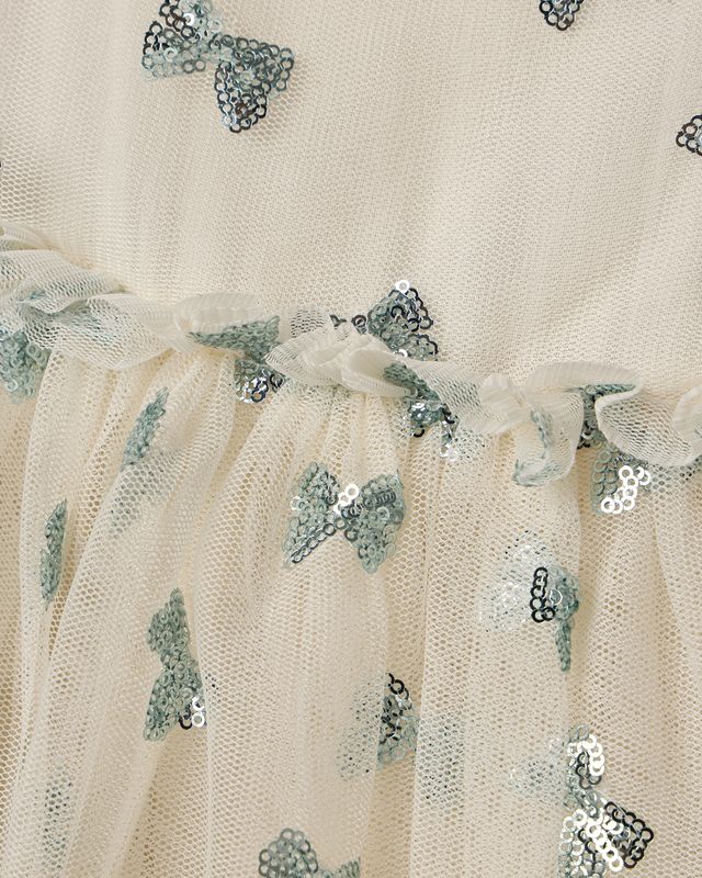 Beige fabric with blue sequin butterfly patterns