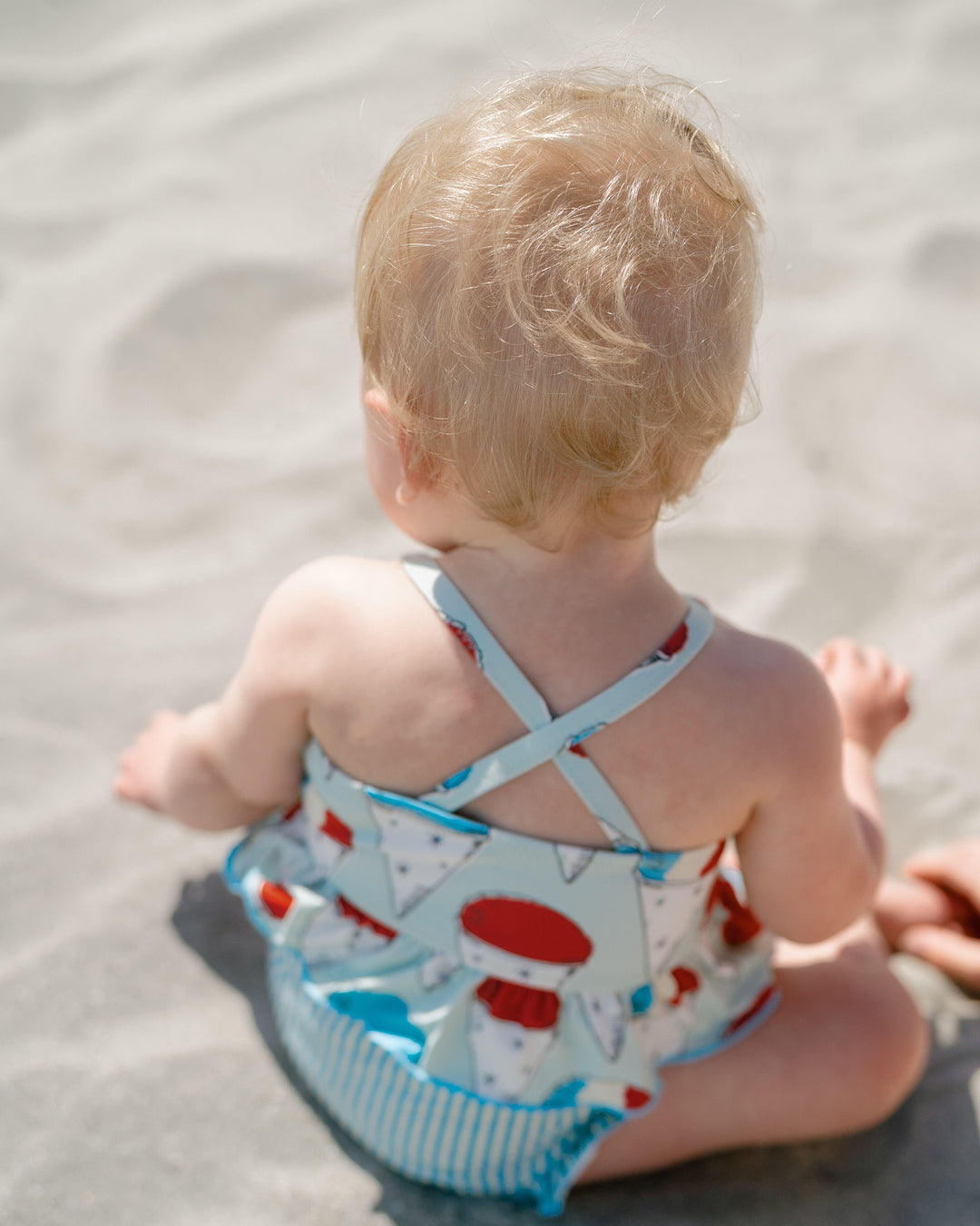 back of baby wearing the snow cone bathing suit. 