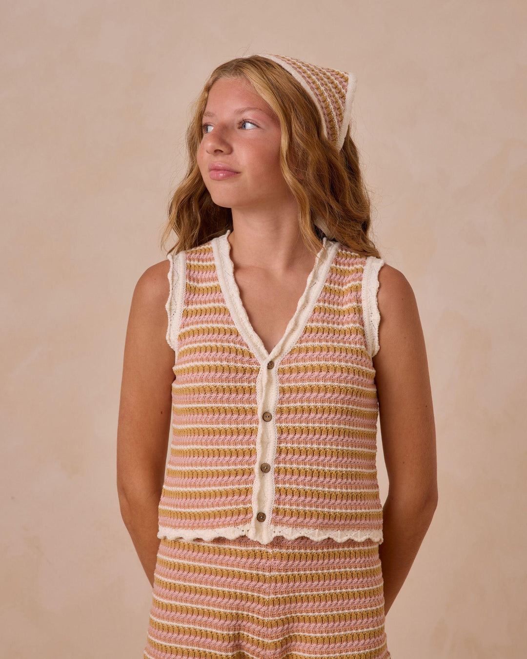 this picture shows the model wearing the crochet stripe set trimmed in beige with a scallop edge