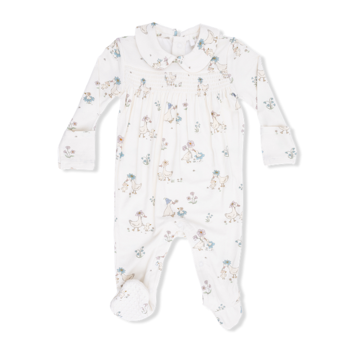 Baby onesie with peter pant collar and smocking with duck and floral pattern on a white background