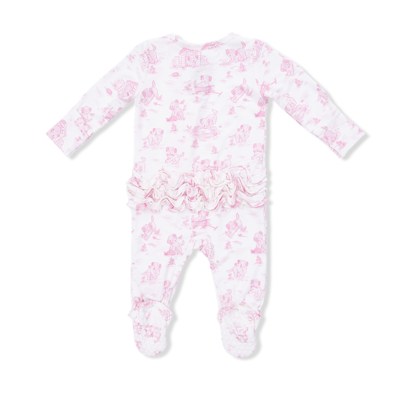 Baby onesie with pink puppy pattern and ruffles on the bottom on a white background