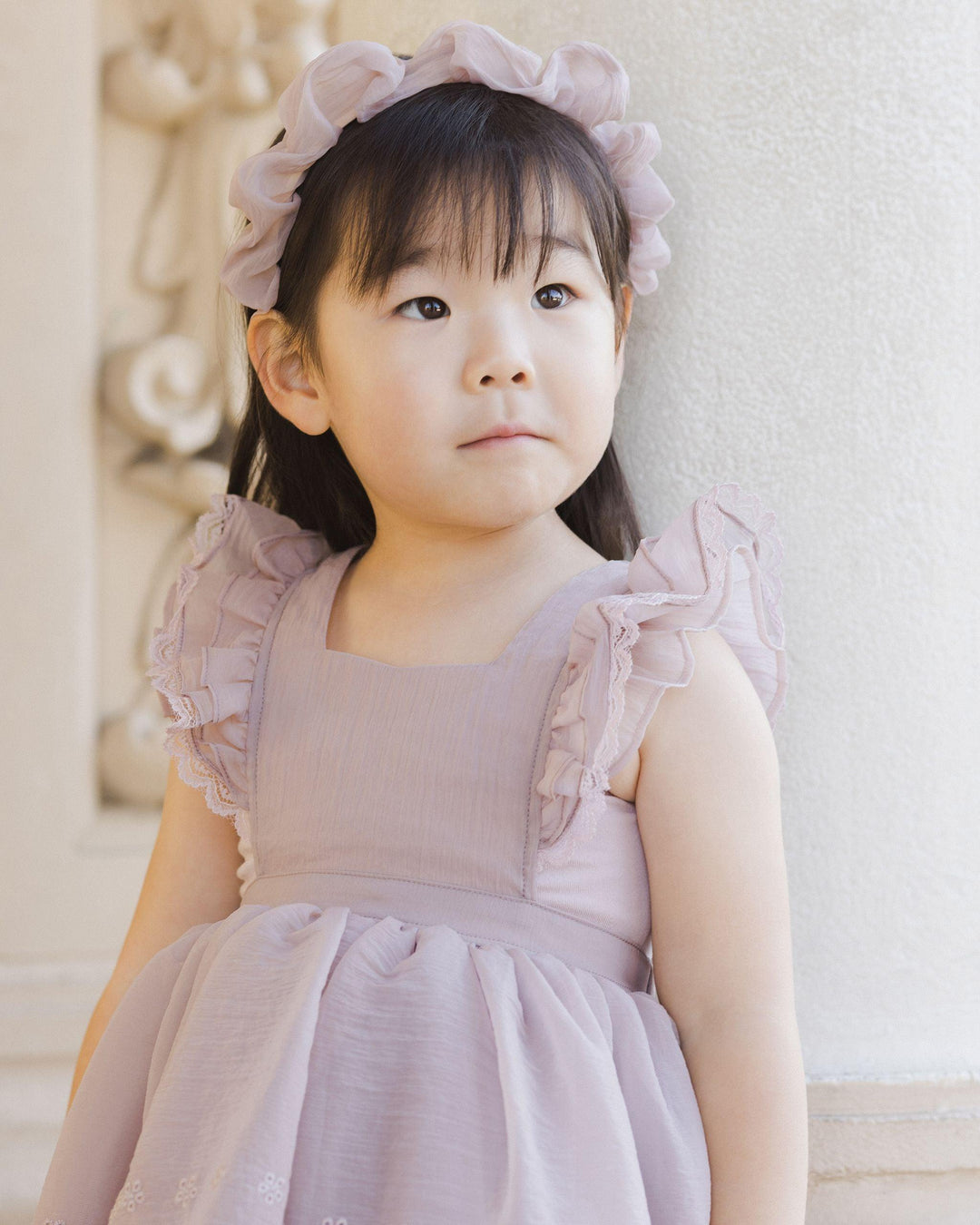 front of lavender pinafore dress with ruffle at the sleeves and how pretty the organza fabric is. 