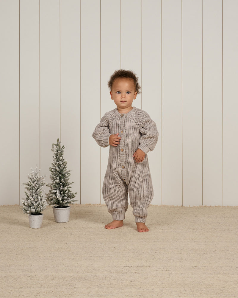 baby boy modeling the chunky knit jumpsuit. 