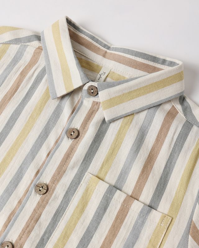 Close-up of a striped shirt with a collar and buttons on a light background