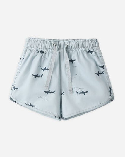 Light blue shorts with shark pattern on a white background