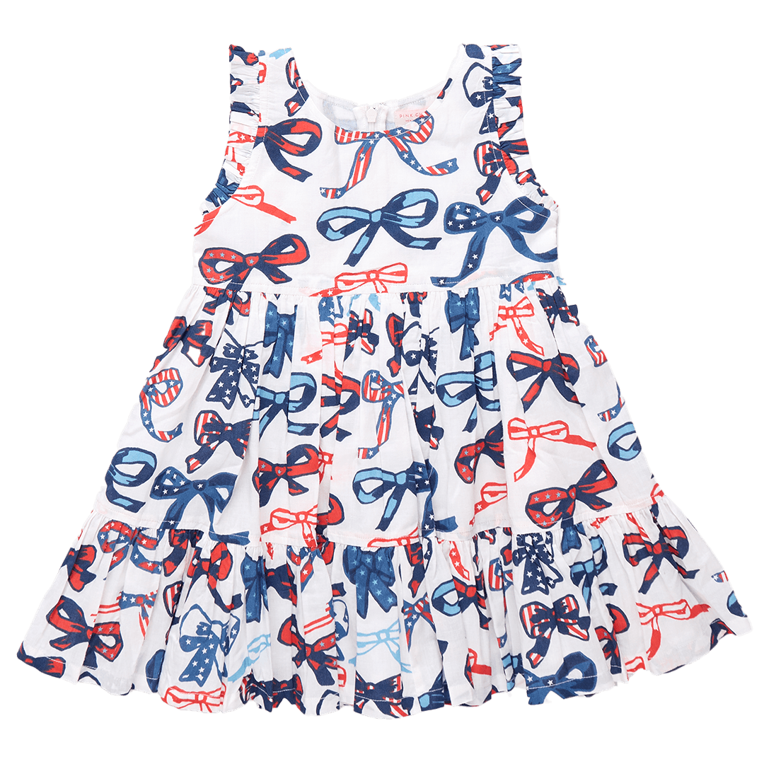 sleeveless dress, white background with red and white blue stripes and stars in the bows. 