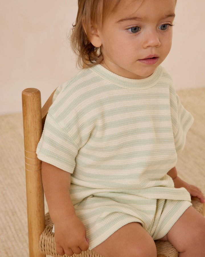 pastel green and beige short sleeve waffle set. little boy modeling the set. 