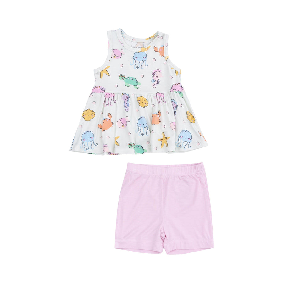 peplum top and bike shorts. shorts are lavender pink and top is white with all different sea creatures on it: octopus, turtle, star fish, crab-- they all look illustrated and sweet. 