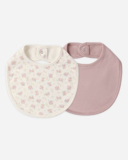 set of 2 bibs, one solid pink and the other floral. each with a snap on the back. 